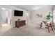 Relaxing carpeted bedroom features a TV, dresser, and inviting chair with plant accent at 1985 Chapel Estates Ln, Dacula, GA 30019