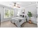 Bedroom with neutral tones, carpet, ceiling fan and natural light from a large window at 1985 Chapel Estates Ln, Dacula, GA 30019