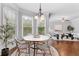 Bright breakfast nook surrounded by windows offering natural light, hardwood floor and table at 1985 Chapel Estates Ln, Dacula, GA 30019