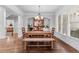 Bright dining room features wood floors, a chandelier, and large windows creating an inviting ambiance at 1985 Chapel Estates Ln, Dacula, GA 30019