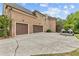 A spacious driveway leads to a three-car garage of this charming two-story brick home on a manicured lawn at 1985 Chapel Estates Ln, Dacula, GA 30019
