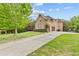 Charming two-story brick home with a three-car garage, a spacious driveway and well-manicured lawn at 1985 Chapel Estates Ln, Dacula, GA 30019