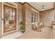 Charming front porch with brick flooring, rocking chairs, and a welcoming atmosphere for relaxing outdoors at 1985 Chapel Estates Ln, Dacula, GA 30019