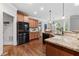 Bright kitchen features granite countertops, stainless steel appliances, and wood floors at 1985 Chapel Estates Ln, Dacula, GA 30019