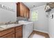 Laundry room with granite countertops, wood cabinets and washer/dryer at 1985 Chapel Estates Ln, Dacula, GA 30019