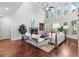 Sunlit living room with soaring ceilings, hardwood floors, and a cozy fireplace, perfect for relaxation and entertaining at 1985 Chapel Estates Ln, Dacula, GA 30019