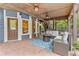 A spacious covered outdoor patio with comfortable seating, a fireplace, and ample outdoor space at 1985 Chapel Estates Ln, Dacula, GA 30019