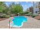 Backyard pool area with lush landscaping, patio seating, and ample space for entertaining at 1985 Chapel Estates Ln, Dacula, GA 30019