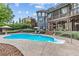 Backyard pool with lush landscaping, patio seating, a raised deck, and a multi-story home at 1985 Chapel Estates Ln, Dacula, GA 30019