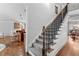 Staircase featuring carpeted steps and a wrought iron railing, leading to the upper level of the home at 1985 Chapel Estates Ln, Dacula, GA 30019