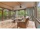 Cozy screened-in porch with comfortable seating, ceiling fans, and tile flooring at 1985 Chapel Estates Ln, Dacula, GA 30019