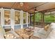 Inviting sunroom with comfortable wicker seating and beautiful views of the wooded backyard at 1985 Chapel Estates Ln, Dacula, GA 30019
