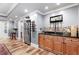 The wet bar has wood cabinets, dark granite countertops and stainless steel refrigerator at 1985 Chapel Estates Ln, Dacula, GA 30019