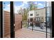 Balcony with wood floors and a black railing overlooking a modern home at 2329 Mason Dr # D24, Atlanta, GA 30316