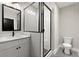 Modern bathroom with glass enclosed shower, white vanity, and patterned tile floors at 2329 Mason Dr # D24, Atlanta, GA 30316