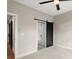 Bedroom with dark ceiling fan and view of bathroom with tub and shower at 2329 Mason Dr # D24, Atlanta, GA 30316