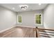 Bonus room features recessed lights, hardwood floors, two windows, and a modern wood/metal railing at 2329 Mason Dr # D24, Atlanta, GA 30316