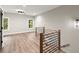 Bonus room featuring a wooden and black metal railing, hardwood floors, and two windows at 2329 Mason Dr # D24, Atlanta, GA 30316