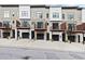 Row of modern townhomes with black garage doors and balconies at 2329 Mason Dr # D24, Atlanta, GA 30316