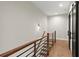 Hallway with modern railing and access to another floor via stairs at 2329 Mason Dr # D24, Atlanta, GA 30316