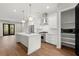Bright, modern kitchen features stainless steel appliances, white cabinetry, and an island with quartz countertop at 2329 Mason Dr # D24, Atlanta, GA 30316