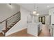 Bright kitchen with quartz countertop, stainless steel appliances, hardwood floors, and modern staircase at 2329 Mason Dr # D24, Atlanta, GA 30316