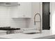 Modern kitchen with quartz countertop, backsplash, stainless steel appliances, and pendant lighting at 2329 Mason Dr # D24, Atlanta, GA 30316