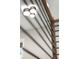 Modern lighting fixture in a bonus room, with a railing visible in the foreground at 2329 Mason Dr # D24, Atlanta, GA 30316