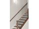 Staircase with wooden steps, black metal railing and a wooden handrail with a modern light fixture at 2329 Mason Dr # D24, Atlanta, GA 30316