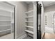 Walk-in closet and a view into the bedroom through a sliding barn door at 2329 Mason Dr # D24, Atlanta, GA 30316