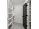 Walk-in closet with built-in shelving, door and neutral carpet at 2329 Mason Dr # D24, Atlanta, GA 30316