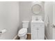 Small bathroom with a toilet and sink and a modern mirror at 429 Tannenhill Pl, Sugar Hill, GA 30518