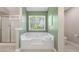 Bathroom featuring a soaking tub and a separate glass shower at 429 Tannenhill Pl, Sugar Hill, GA 30518