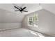 Bright bedroom featuring a ceiling fan, large window, and neutral carpet at 429 Tannenhill Pl, Sugar Hill, GA 30518