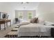 Bright bedroom with neutral walls, a large bed, and a decorative rug at 429 Tannenhill Pl, Sugar Hill, GA 30518