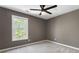Bedroom with a window letting in natural light and neutral-colored walls at 429 Tannenhill Pl, Sugar Hill, GA 30518