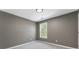 Bedroom with a window letting in natural light and neutral-colored walls at 429 Tannenhill Pl, Sugar Hill, GA 30518