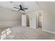Comfortable carpeted bedroom includes a ceiling fan, closet and an entrance to another room at 429 Tannenhill Pl, Sugar Hill, GA 30518