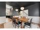 Dining room area with seating for six, black accent walls and a modern light fixture at 429 Tannenhill Pl, Sugar Hill, GA 30518