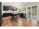 Modern kitchen with dark cabinets, stainless steel appliances, island with stools and a sliding glass door at 429 Tannenhill Pl, Sugar Hill, GA 30518