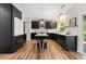 The modern kitchen features dark cabinets, stainless steel appliances, and light countertops at 429 Tannenhill Pl, Sugar Hill, GA 30518