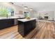 Open-concept kitchen and living room featuring stainless steel appliances and a fireplace at 429 Tannenhill Pl, Sugar Hill, GA 30518