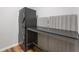 Laundry area with stacked washer and dryer and built-in folding table at 429 Tannenhill Pl, Sugar Hill, GA 30518