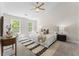 Spacious bedroom with neutral decor, a ceiling fan, and windows, creating a serene retreat at 429 Tannenhill Pl, Sugar Hill, GA 30518
