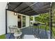 Back patio offers outdoor seating and dining space with a view of the landscaped yard at 429 Tannenhill Pl, Sugar Hill, GA 30518