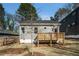 A charming backyard with a wooden deck, perfect for relaxation, and a view of the home's exterior at 102 Dahlia Nw Ave, Atlanta, GA 30314