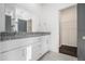 Contemporary bathroom with double vanity, granite countertop, and access to a walk-in closet at 102 Dahlia Nw Ave, Atlanta, GA 30314