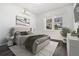 Cozy bedroom with a large window, soft lighting, and modern decor and hardwood floors at 102 Dahlia Nw Ave, Atlanta, GA 30314