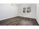 Well-lit bedroom featuring wood-look flooring and natural light from two windows at 102 Dahlia Nw Ave, Atlanta, GA 30314