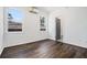 A light-filled bedroom with wood-look flooring, white walls, and two windows at 102 Dahlia Nw Ave, Atlanta, GA 30314